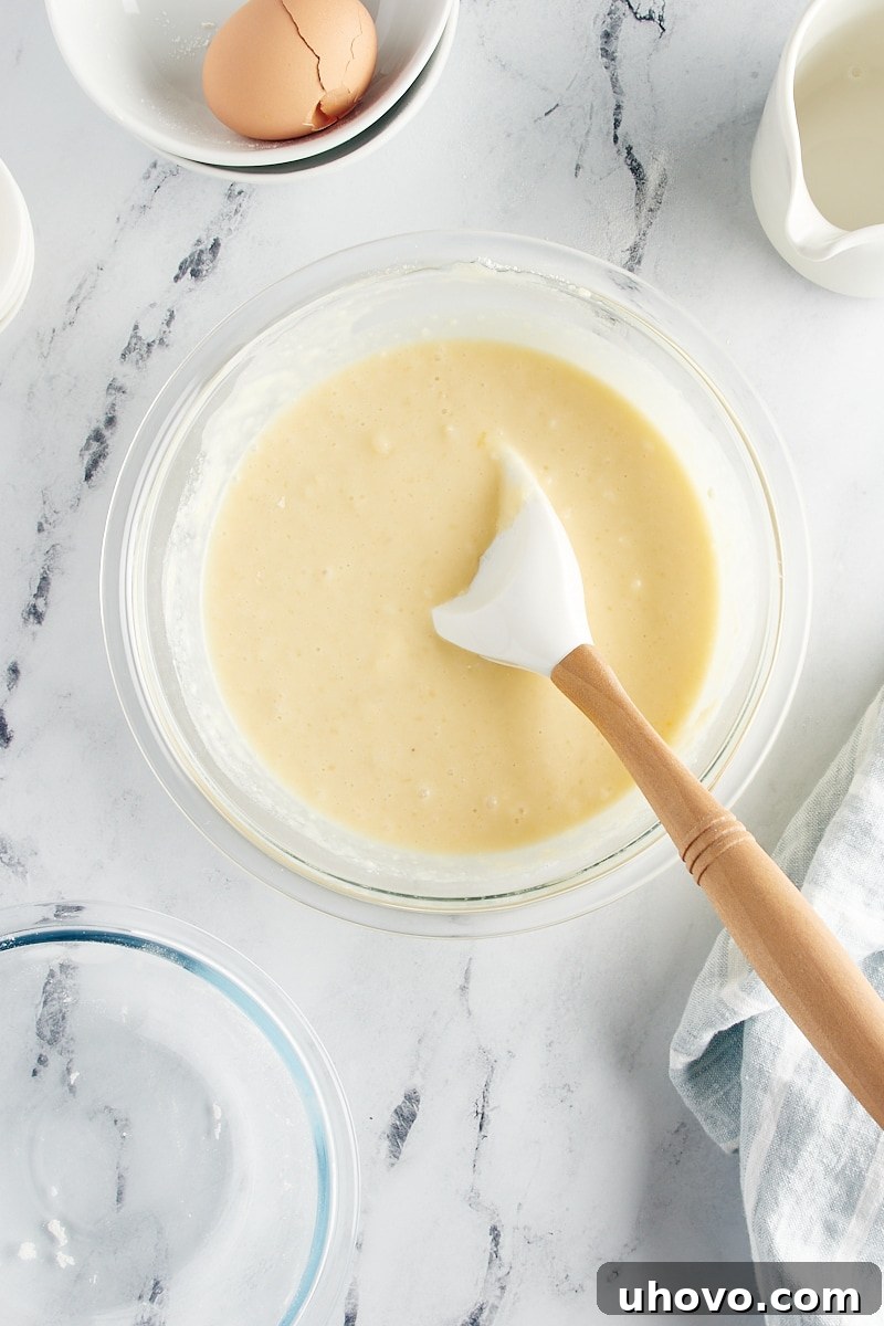 A close-up of the perfectly mixed cake batter for the Vanilla Pudding Cake, smooth and lump-free.