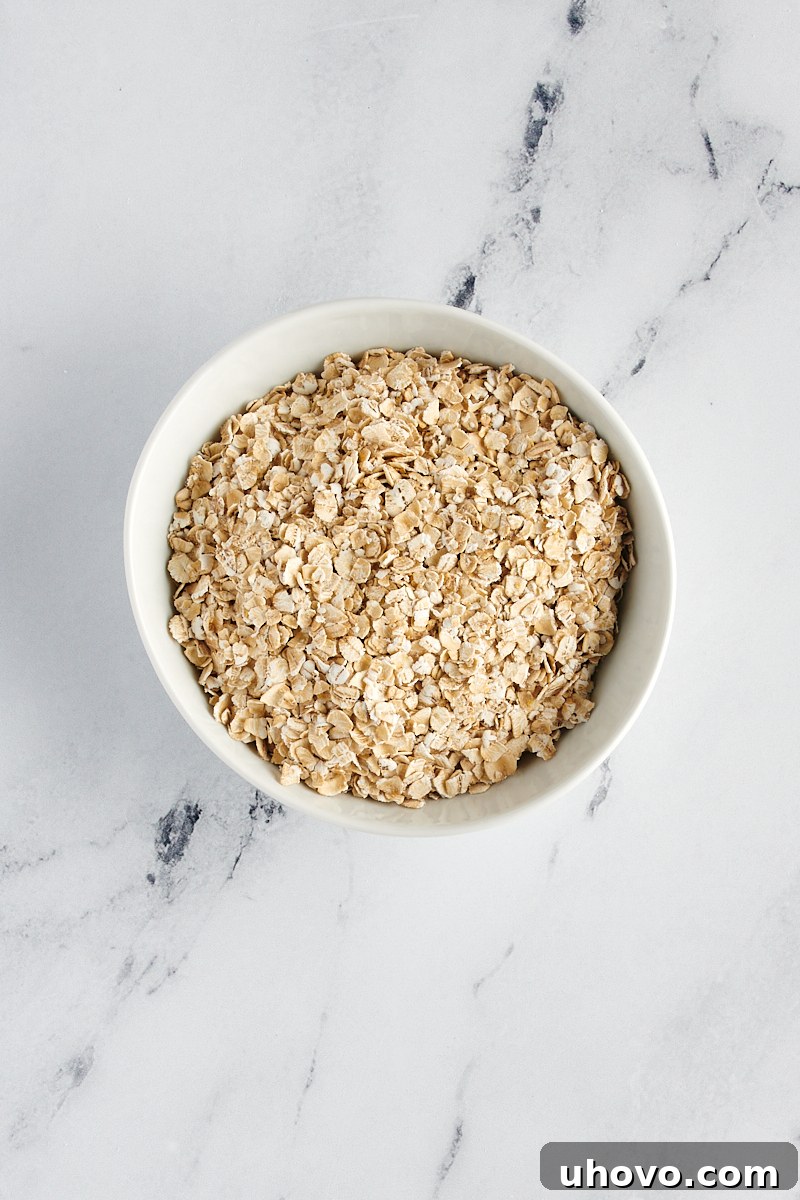 overhead view of quick oats in a white bowl on a marble surface