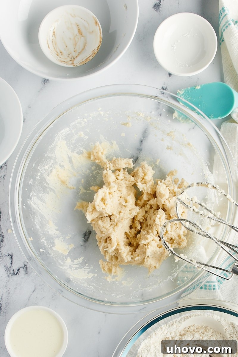 Overhead view of creamed butter in a mixing bowl.