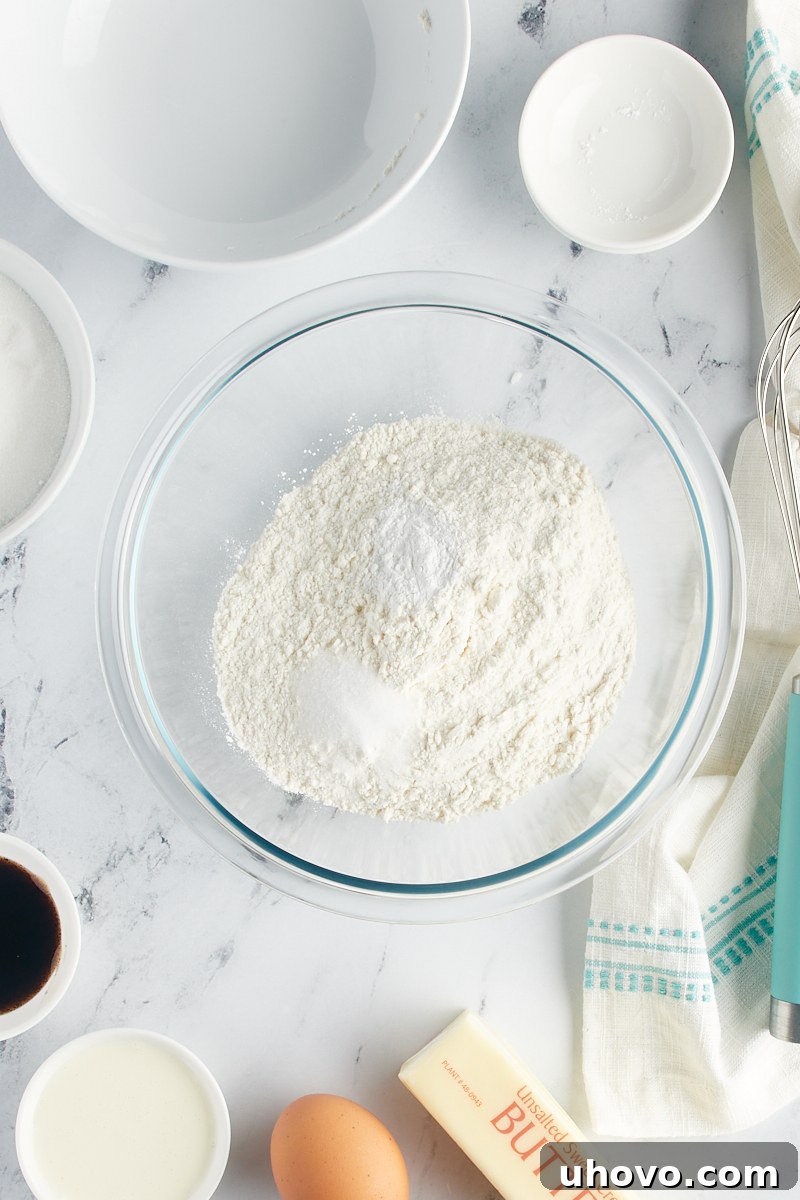 Overhead view of dry ingredients in a glass mixing bowl.