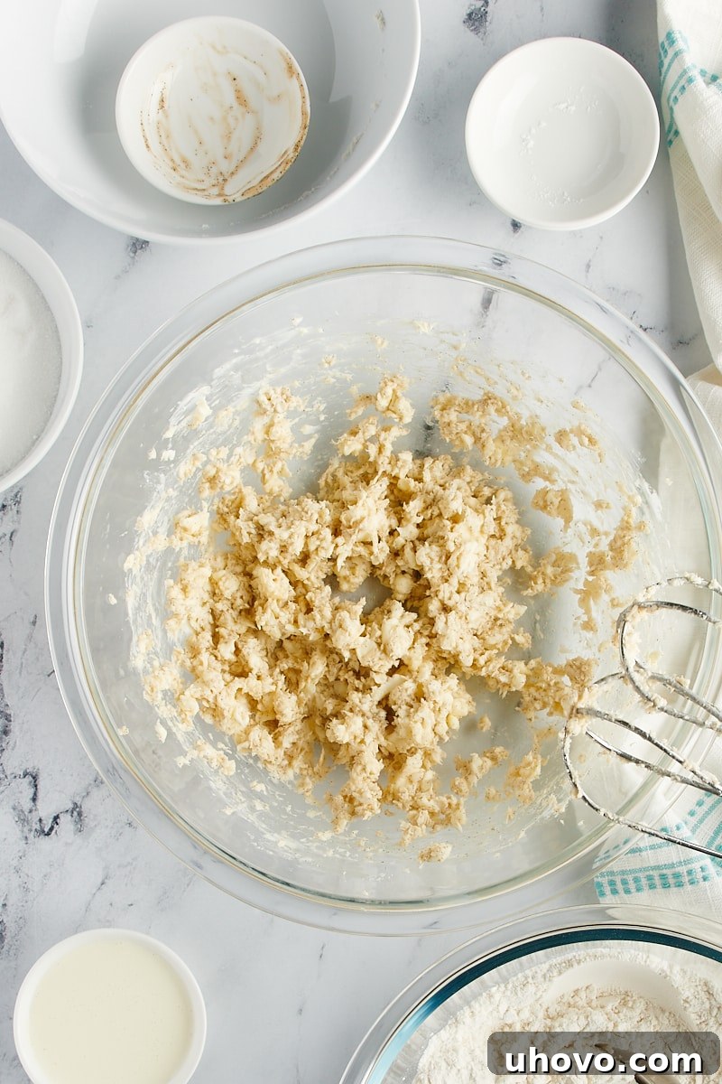 Overhead view of a butter and vanilla mixture in a glass bowl.