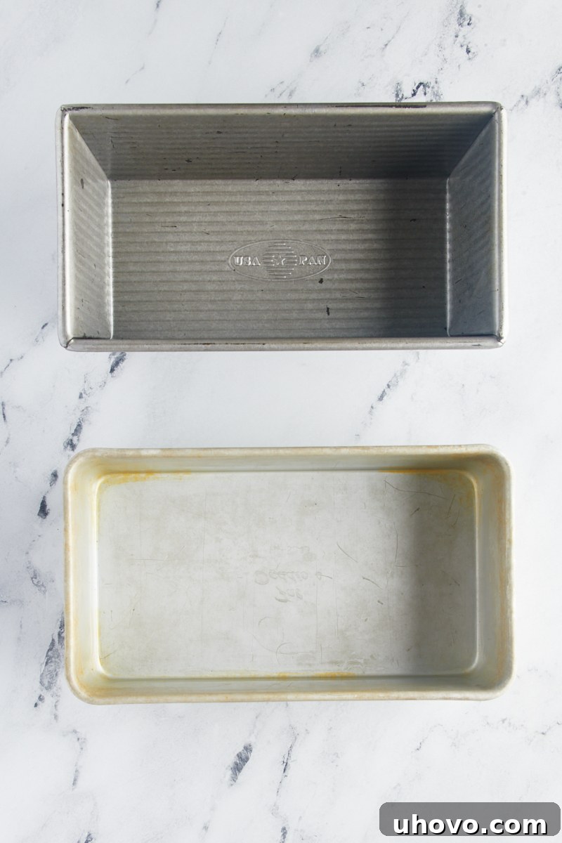 overhead view of two loaf pans on a marble surface