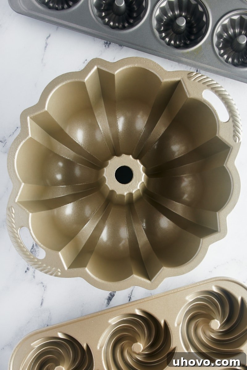 overhead view of a classic Bundt pan with a mini Bundt pan and Bundtlette pan next to it
