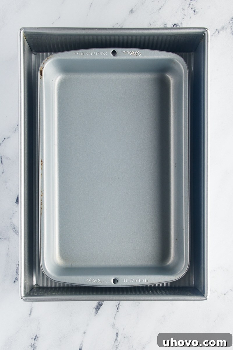 overhead view of an 11" x 7" baking pan nested inside a 9" x 13" baking pan