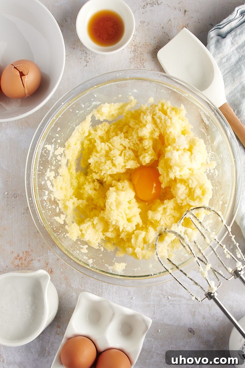 overhead view of a second egg incorporated into the coconut cake batter