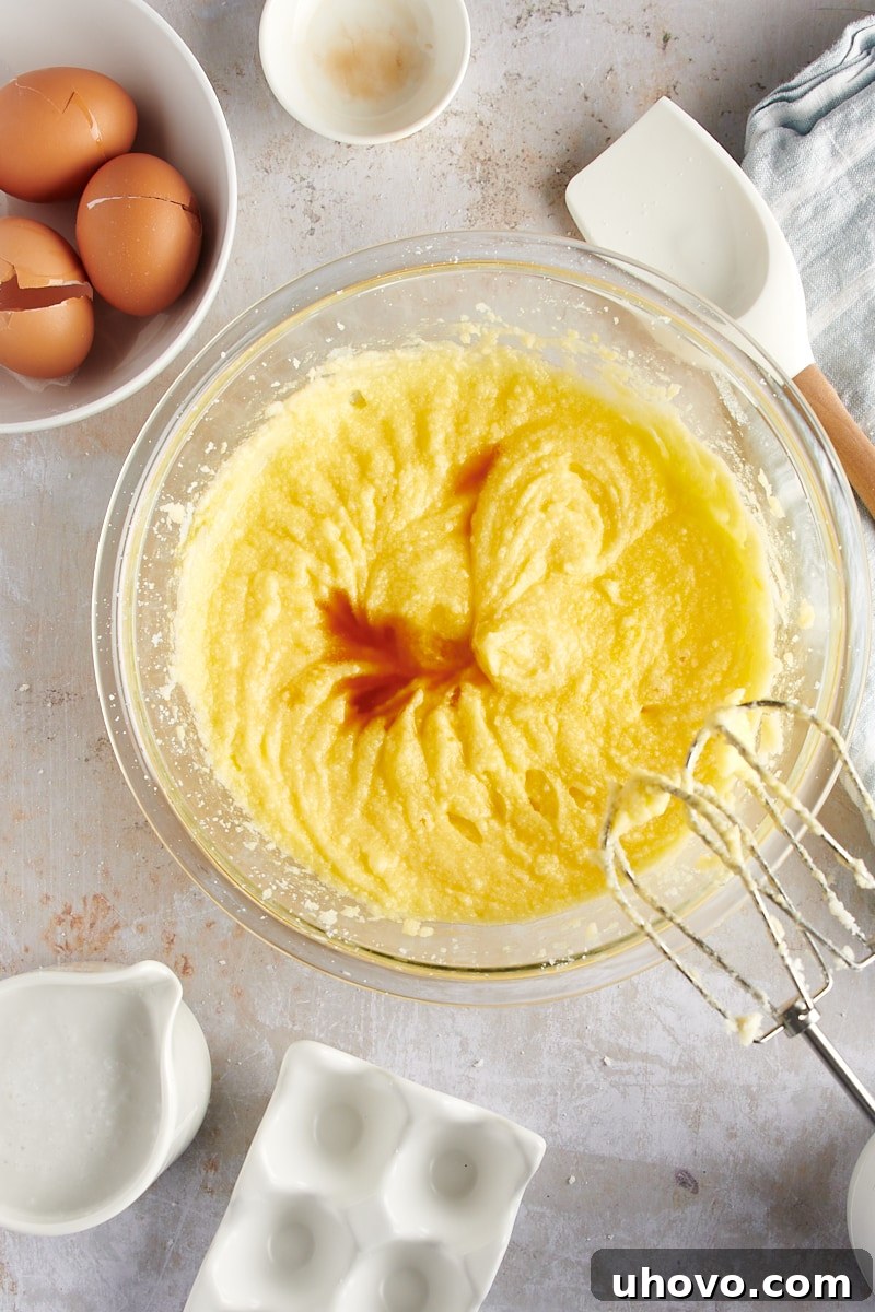 overhead view of vanilla extract being mixed into the smooth cake batter