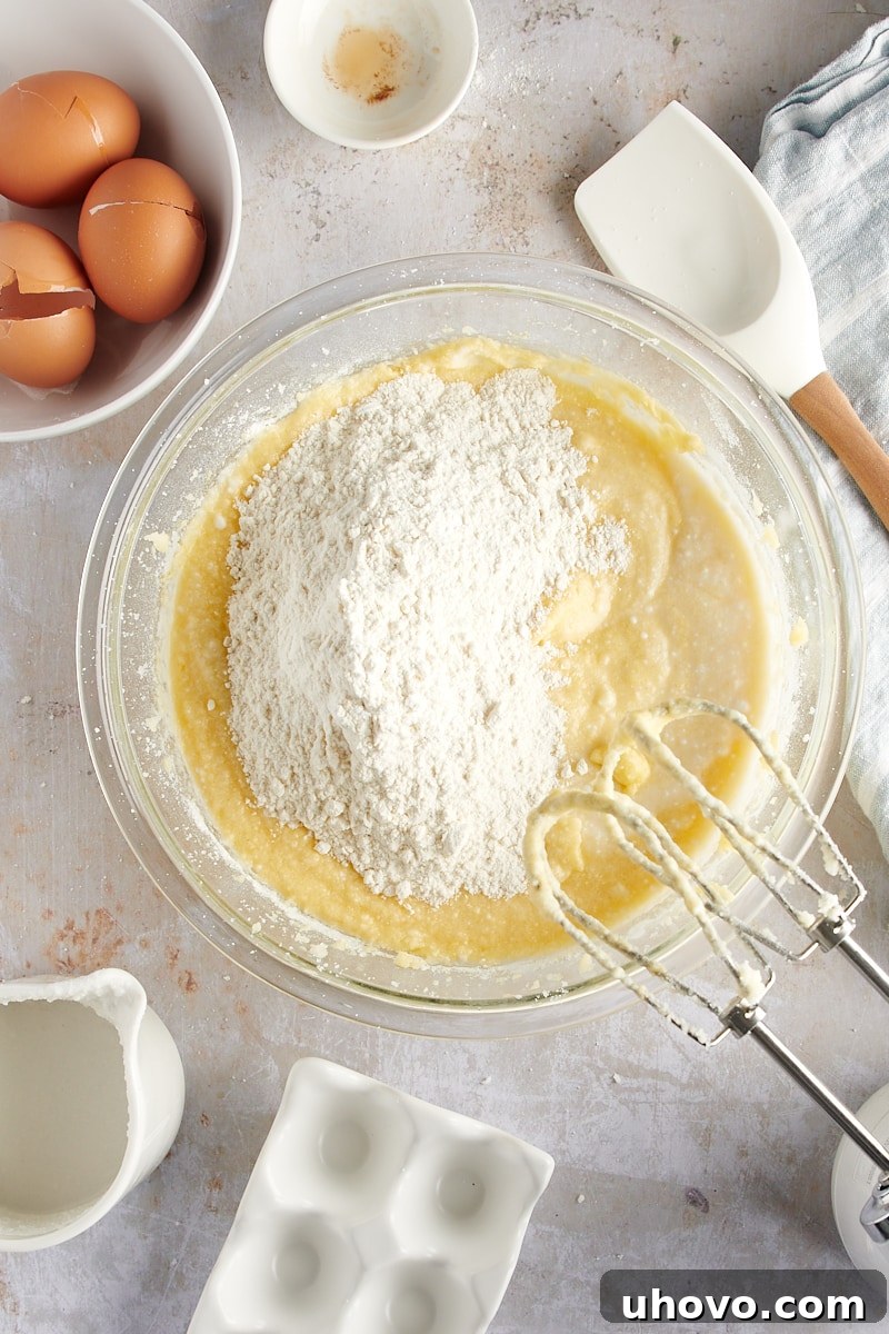 overhead view of a second portion of dry ingredients being folded into the cake batter