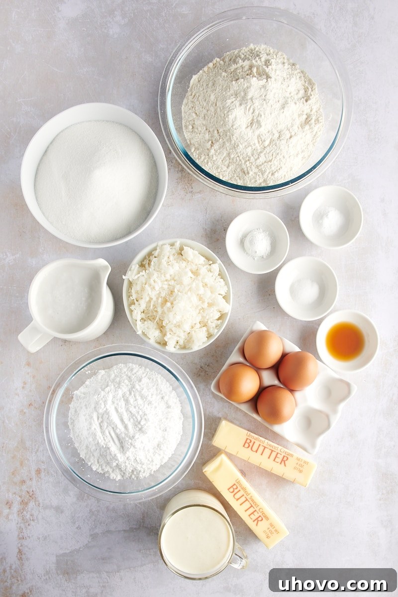 overhead view of ingredients for Coconut Sheet Cake, neatly arranged on a white surface
