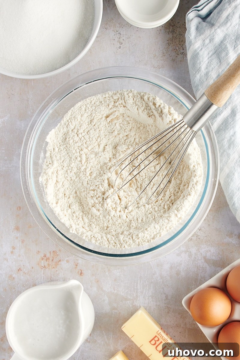overhead view of mixed dry ingredients for Coconut Sheet Cake, showing them well combined