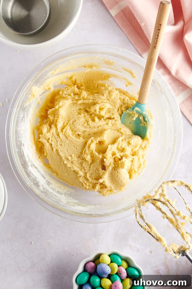 overhead view of fully mixed sugar cookie dough in a glass mixing bowl, perfectly combined