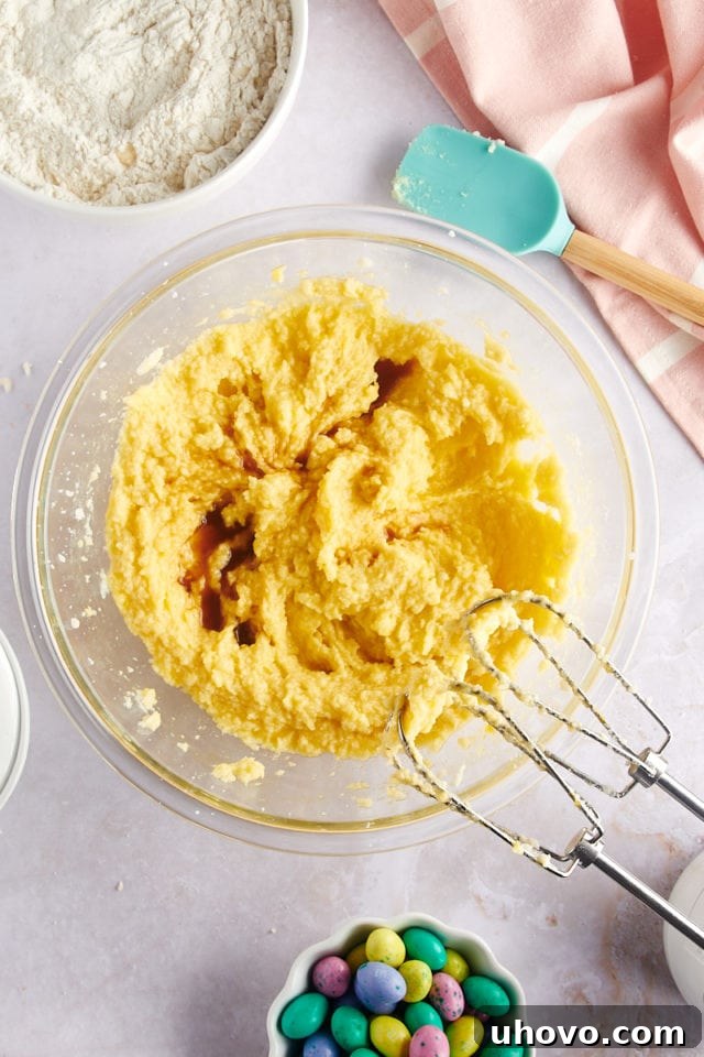 overhead view of vanilla extract being mixed into the cookie dough ingredients