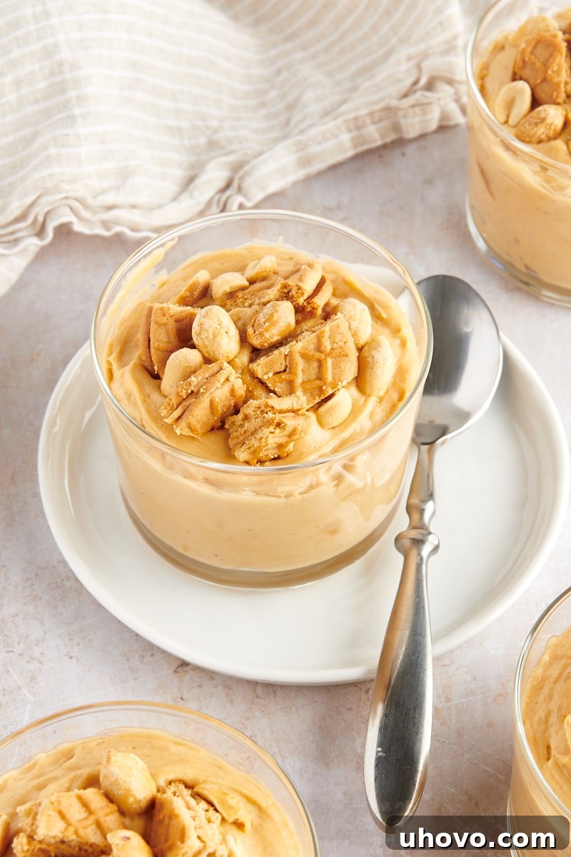a serving of Peanut Butter Mousse in a glass on a white plate