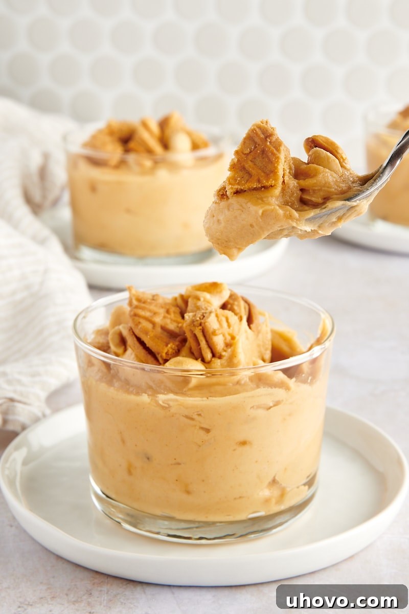 a spoonful of Peanut Butter Mousse over a glass filled with more mousse
