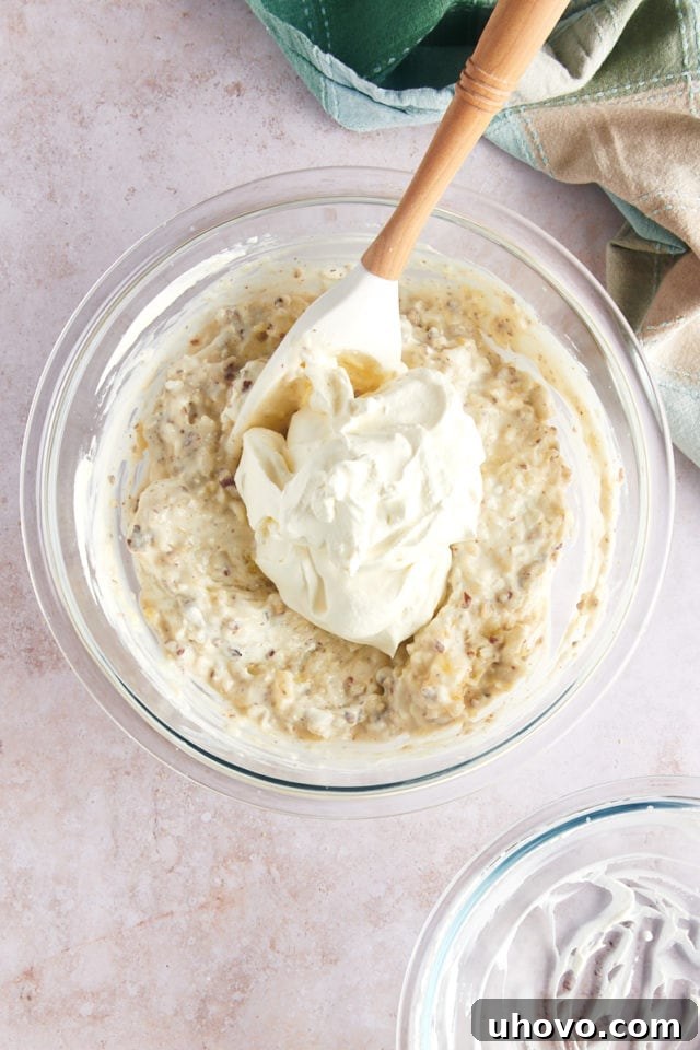 Overhead view of whipped cream added to bowl of pie filling