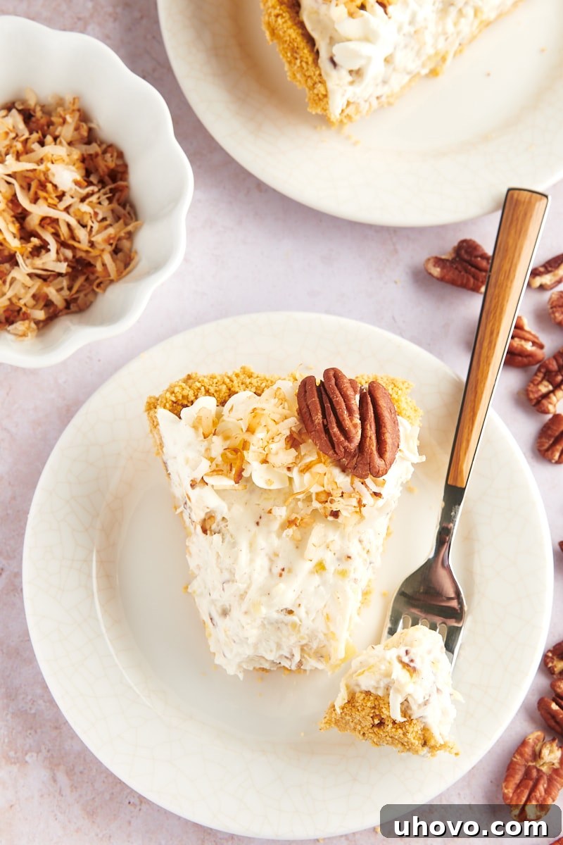 Overhead view of Slice of millionaire pie on plate with tip of pie on fork