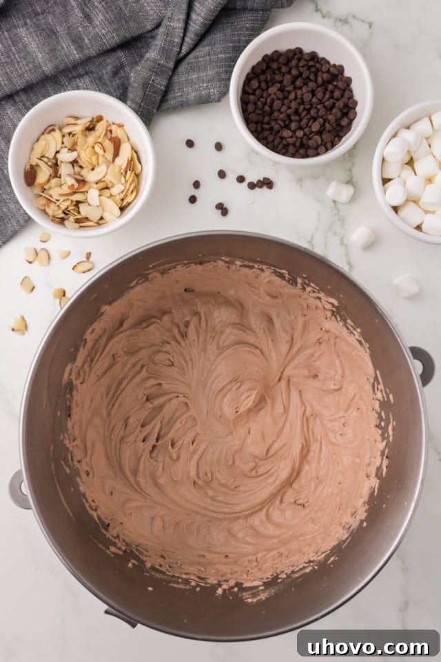 An overhead view of the rich, smooth chocolate ice cream base in a metal mixing bowl, perfectly whipped and ready for the next step.