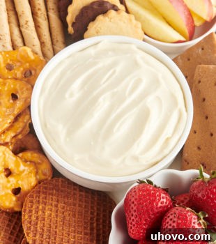 Bowl of cheesecake dip surrounded by assorted dippers