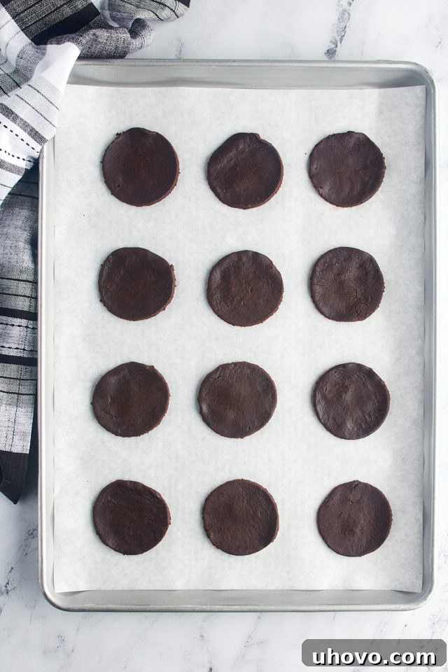 overhead view of chocolate wafer cookies on a parchment-lined baking sheet ready to go into the oven
