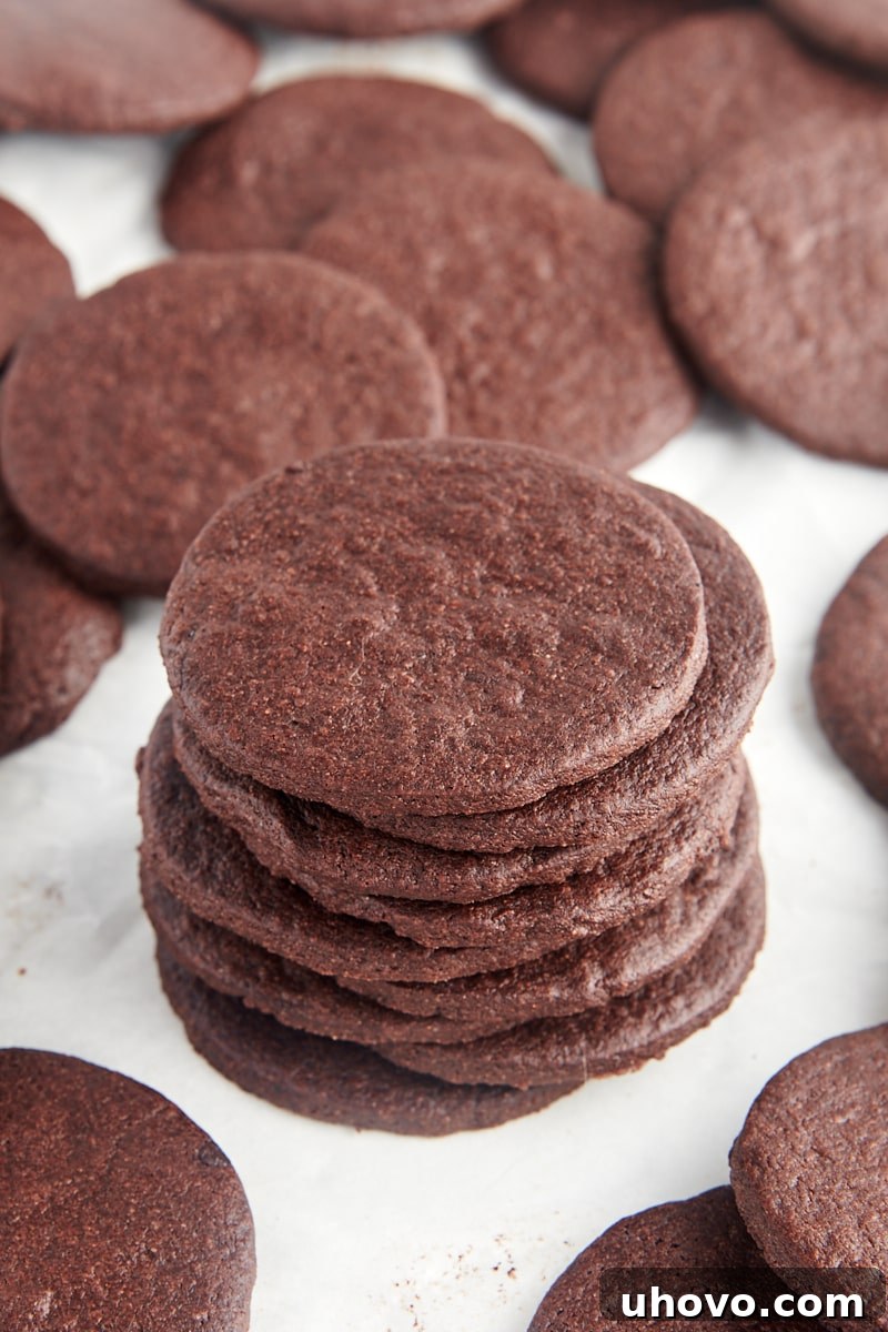 stack of nine chocolate wafer cookies surrounded by more cookies