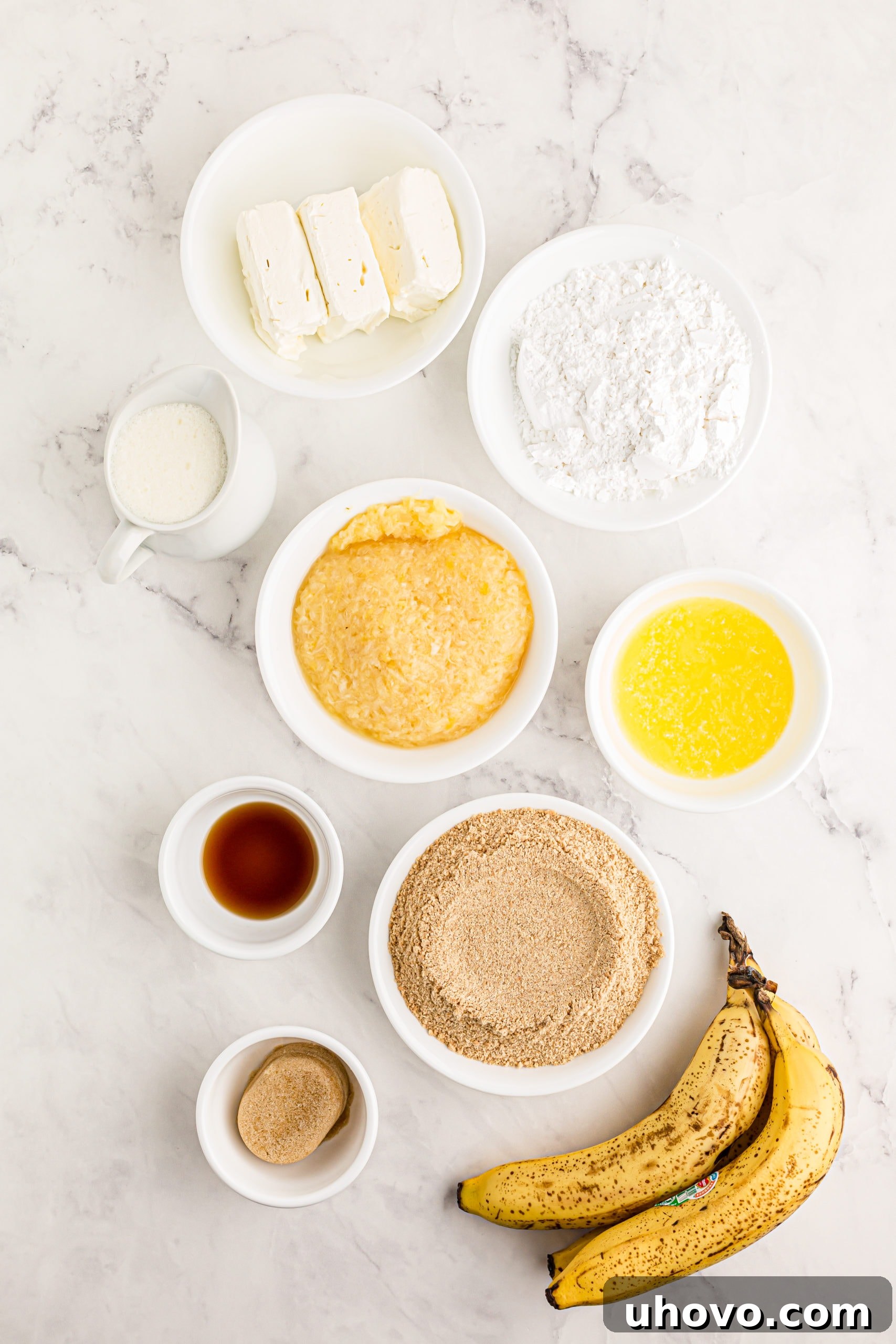 Overhead view of fresh ingredients for a homemade banana split cake arranged on a counter.