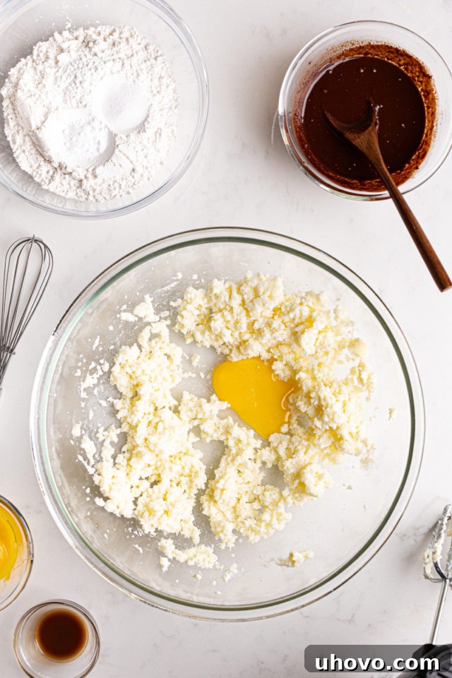 Creamed butter and sugar with egg yolk, forming a pale yellow, fluffy mixture in a mixing bowl for the cake batter.