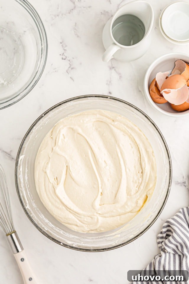 Overhead view of cake batter in glass mixing bowl