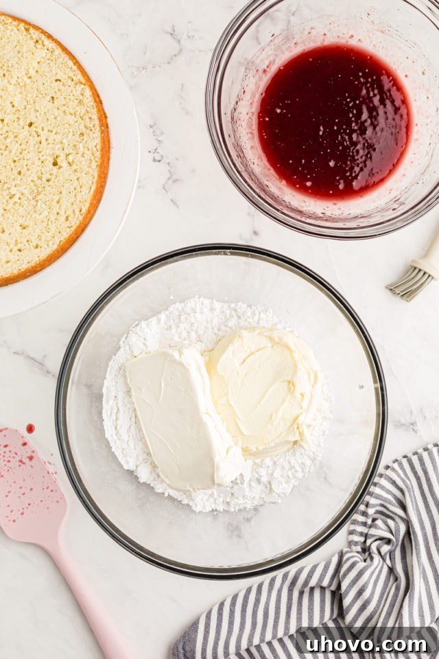 Overhead view of powdered sugar, mascarpone, and cream cheese in mixing bowl before combining