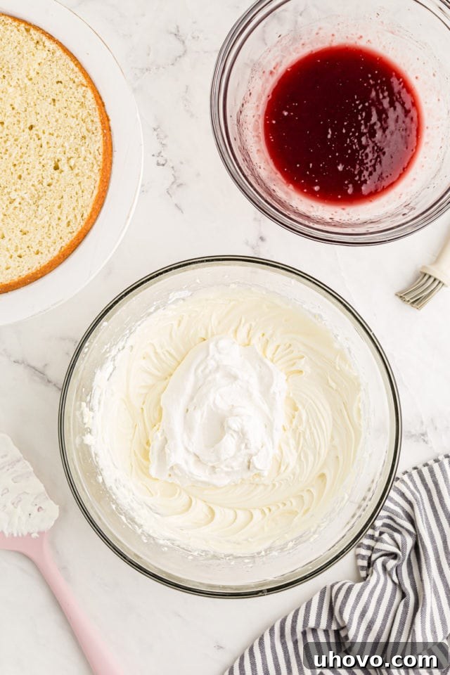 Overhead view of small amount of whipped cream added to mascarpone and cream cheese