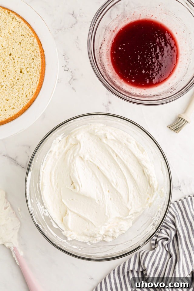 Overhead view of raspberry jam mixture and frosting in mixing bowls