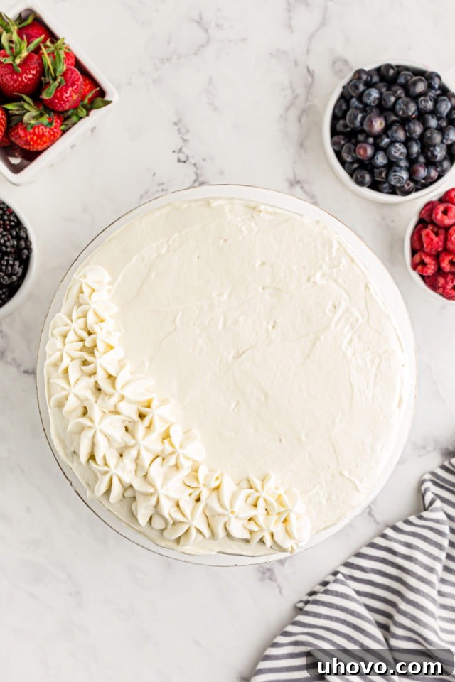 Overhead view of chantilly cake with stars piped on left side for decoration