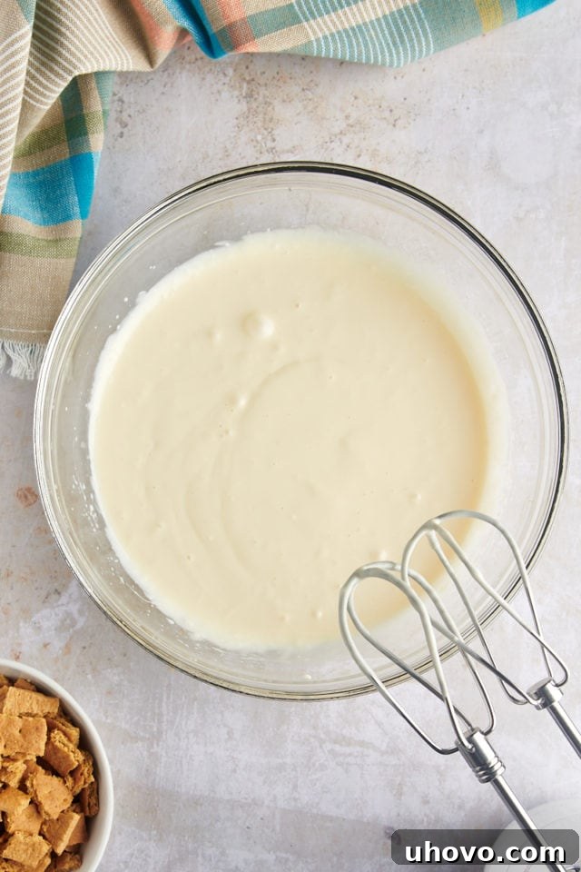 Overhead view of cream cheese mixture in mixing bowl