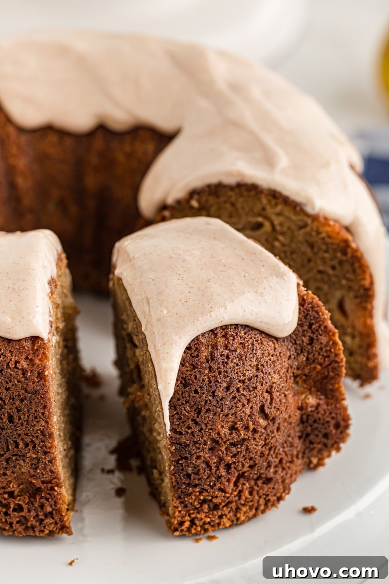 A slice being taken out of glazed spiced pear cake