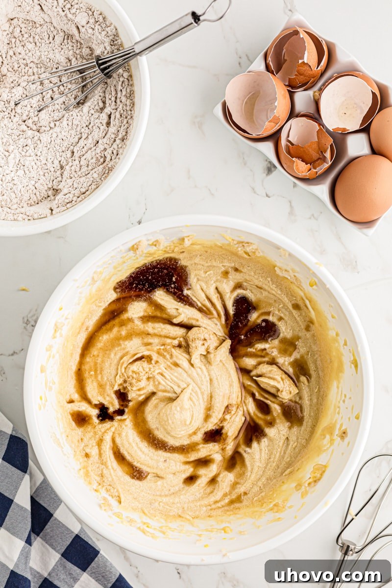 Adding vanilla to the pear cake batter