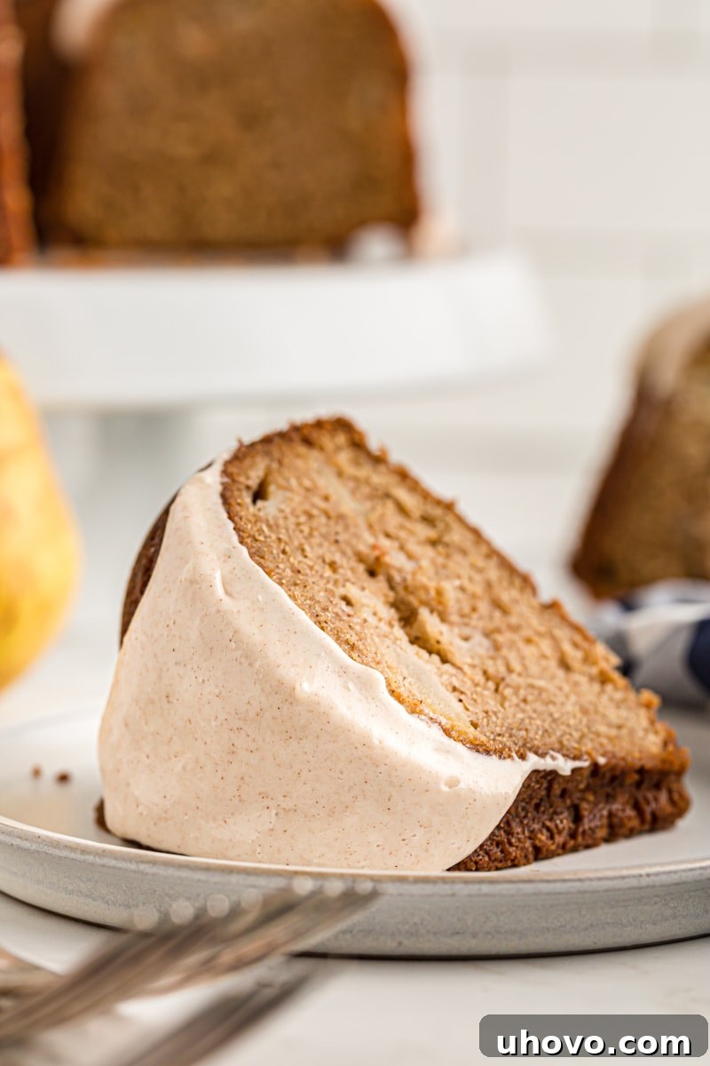 A slice of pear cake on a white plate