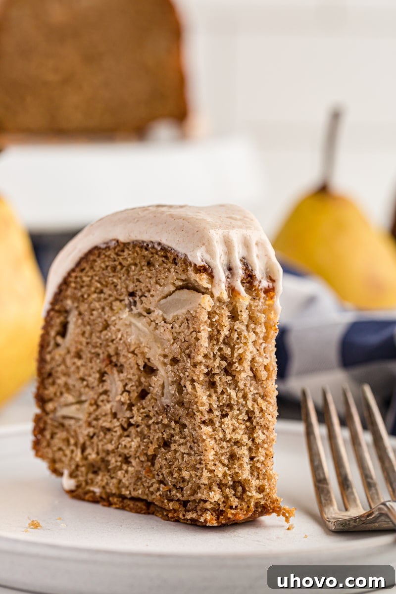 a partial slice of pear cake on a white plate