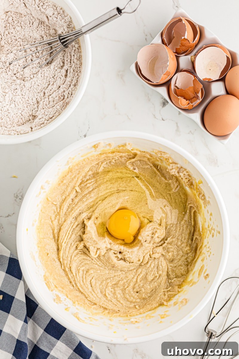 Adding eggs to the cake batter