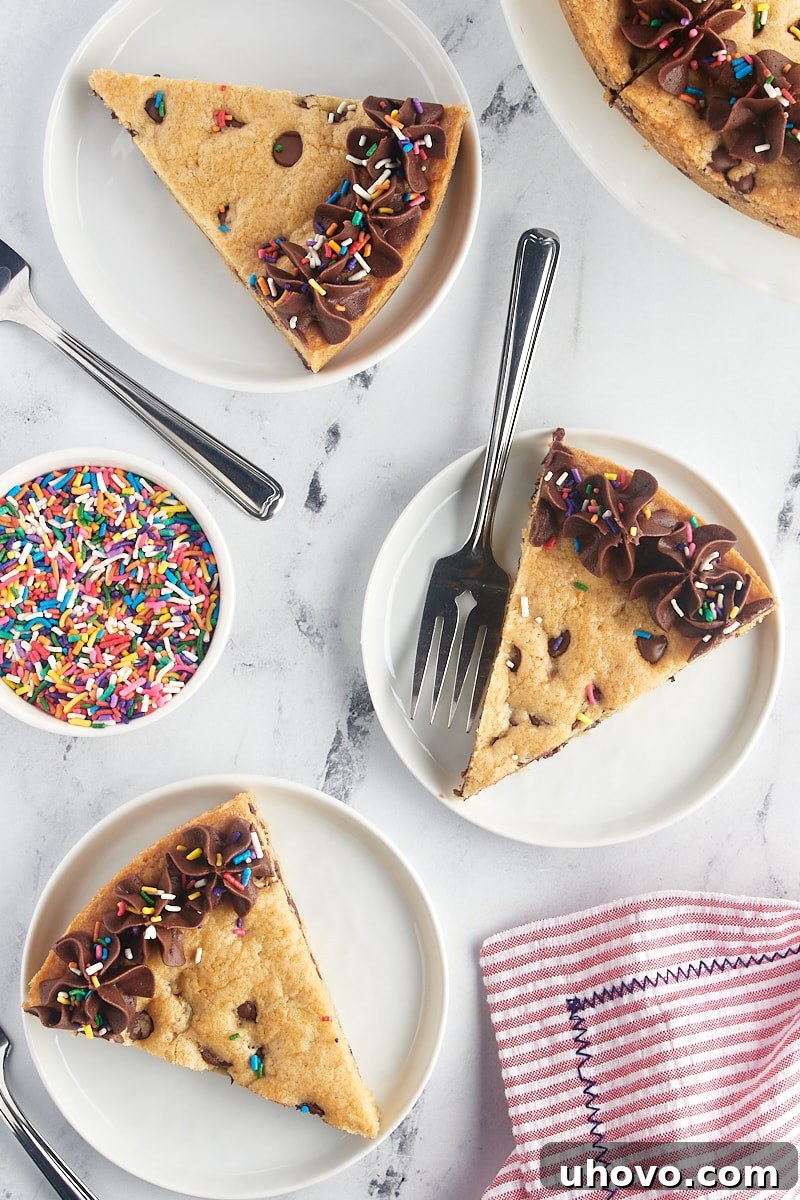 An inviting overhead view of multiple slices of chocolate chip cookie cake, each on its own white plate, showcasing the dessert's readiness for sharing and enjoyment.