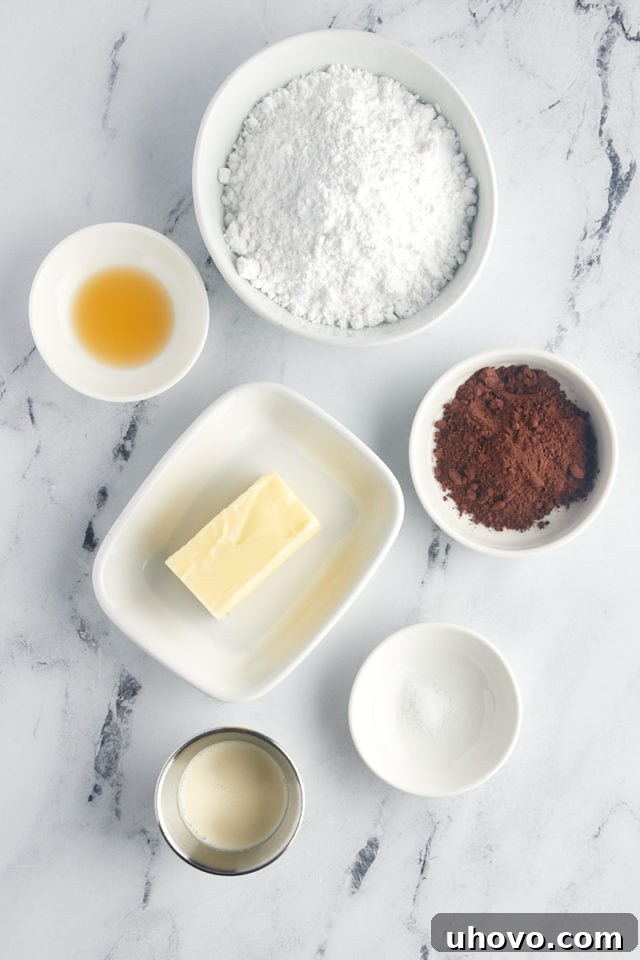 A close-up, overhead view of the essential ingredients laid out for making the luscious chocolate frosting that will top the cookie cake.