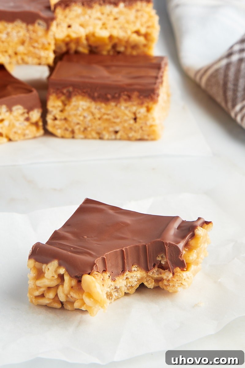 Scotcheroo with bite taken out of corner, with additional bars in background, inviting a taste.