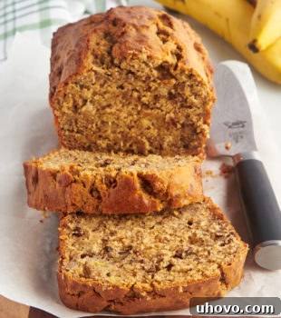 Sliced peanut butter banana bread on cutting board with knife