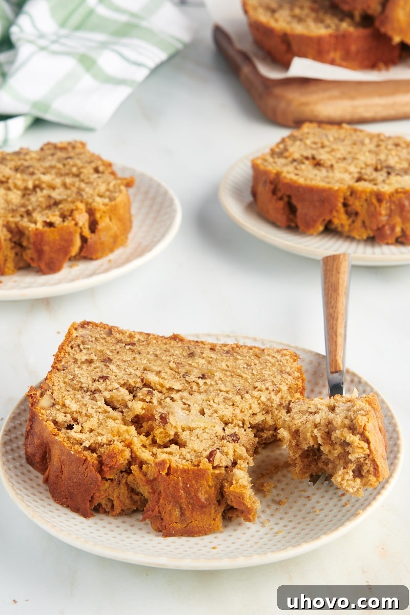 Slices of golden-brown peanut butter banana bread neatly arranged on elegant white plates, ready to be served.