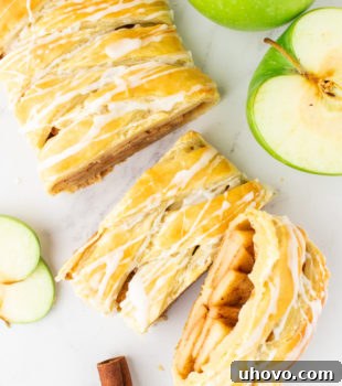 overhead view of sliced apple strudel on a marble surface