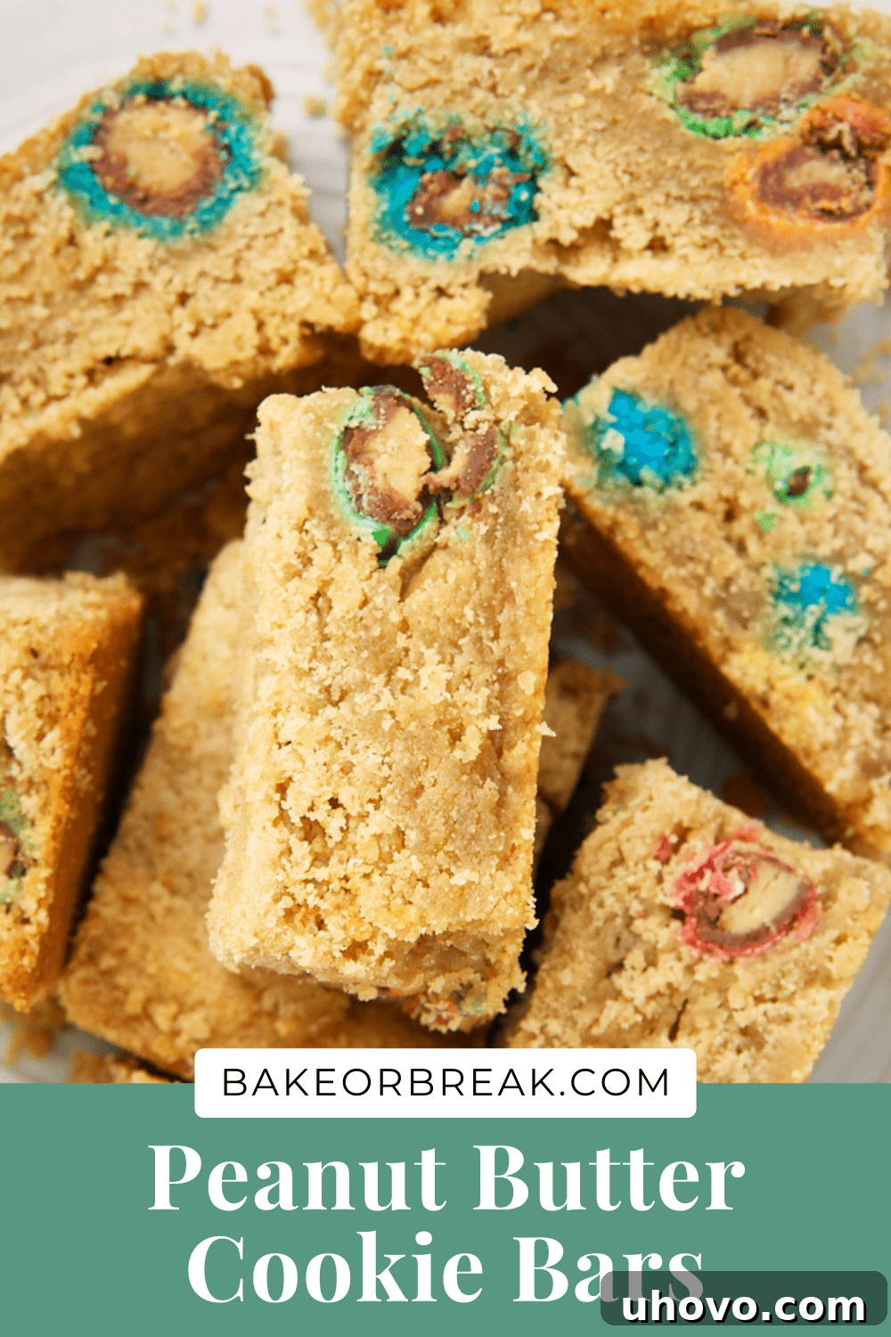 Close-up of Peanut Butter Cookie Bars from bakeorbreak.com, showing the texture and M&Ms, with a branding overlay.
