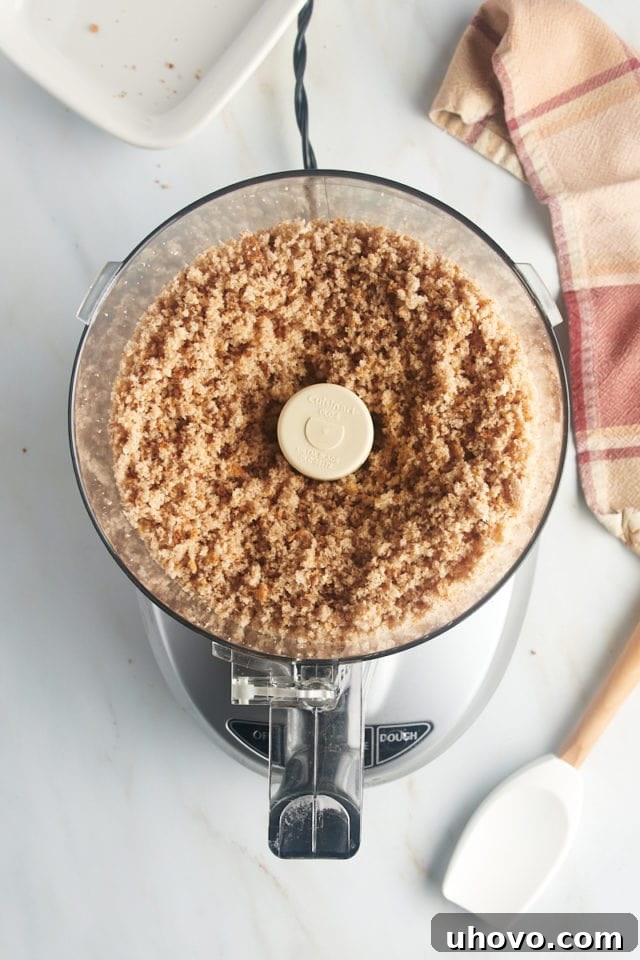 Overhead view of coarse breadcrumbs in food processor bowl after pulsing.