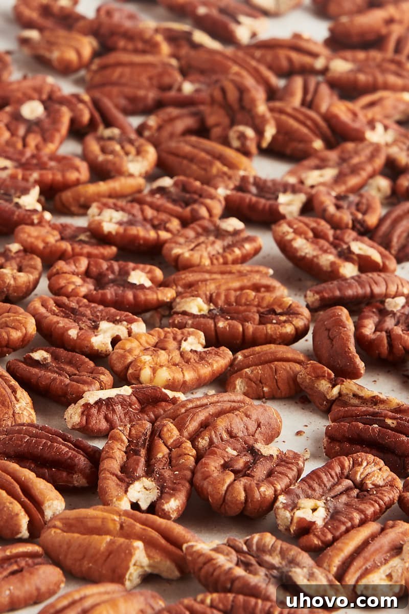 toasted pecans scattered on parchment paper