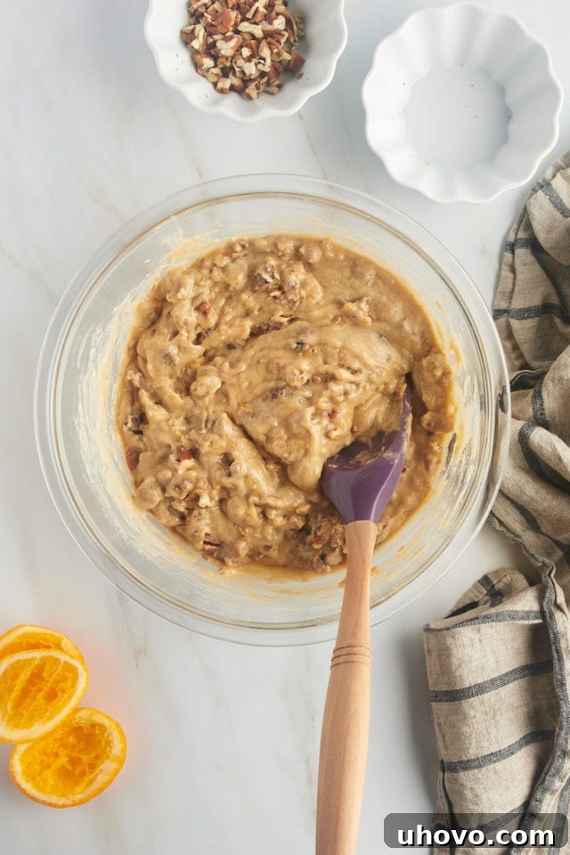 overhead view of mixed date nut muffin batter in a glass mixing bowl