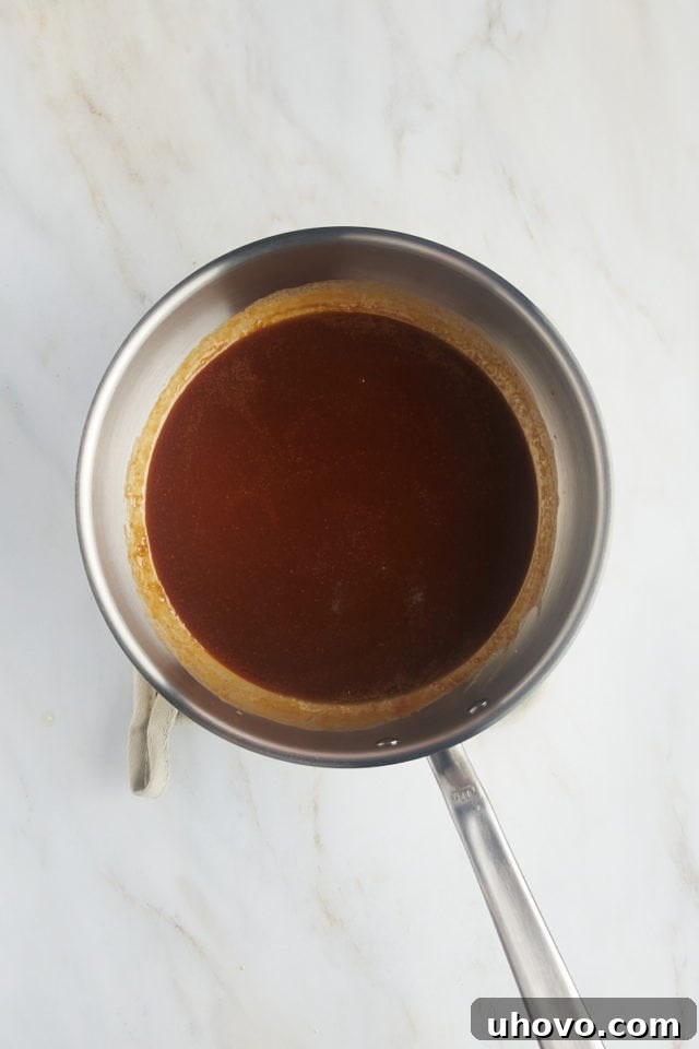 Overhead view of the finished, smooth caramel sauce in a saucepan, ready to cool.
