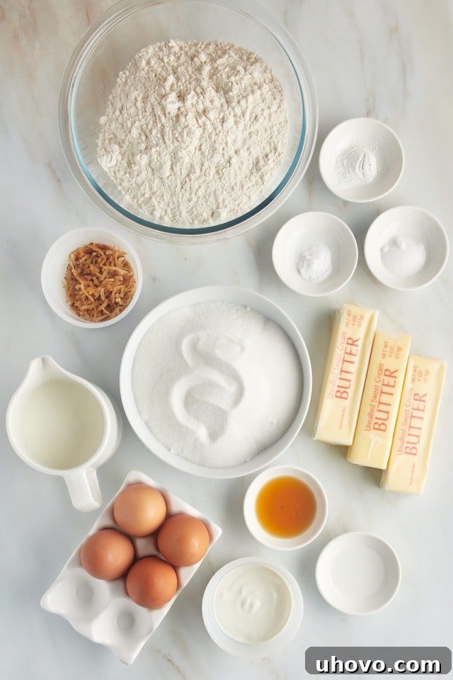An overhead view displaying all the essential dry and wet ingredients neatly laid out for preparing the Louisiana Crunch Cake batter, including flour, sugar, butter, and eggs.