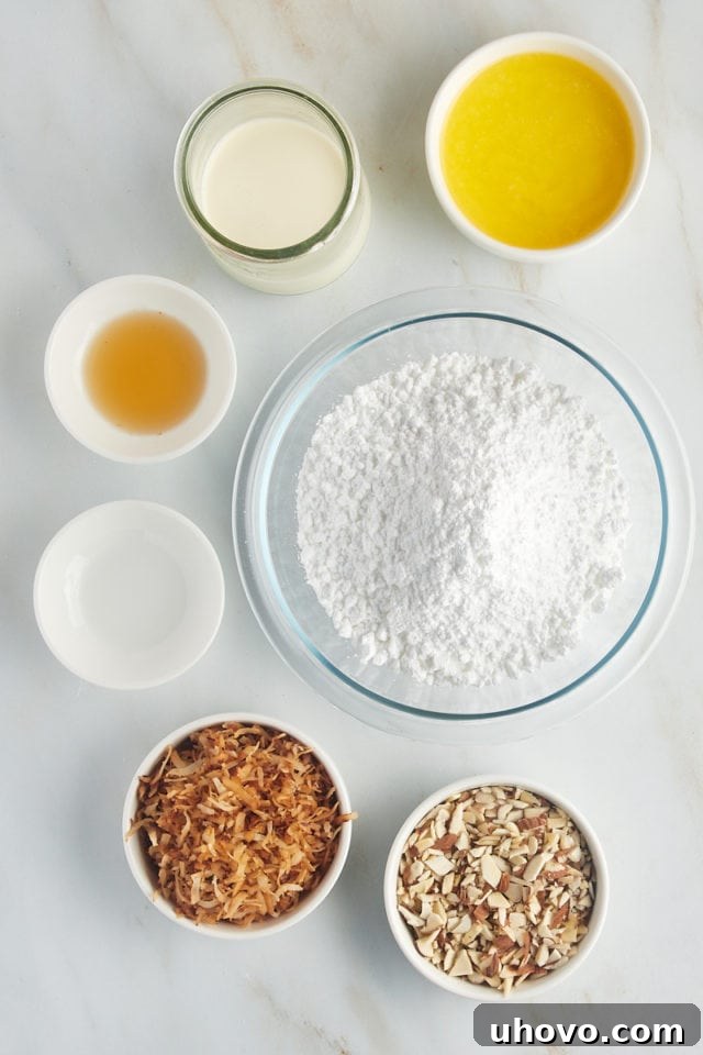 An overhead shot showcasing the ingredients specifically for the rich glaze and delightful toppings of the Louisiana Crunch Cake, such as confectioners' sugar, melted butter, and coconut flakes.