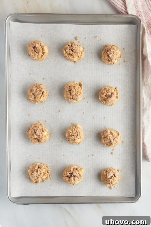 Overhead view of portioned apple cookie dough topped with crumb topping.